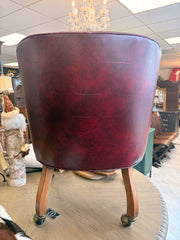 Tufted burgundy chair on casters ￼